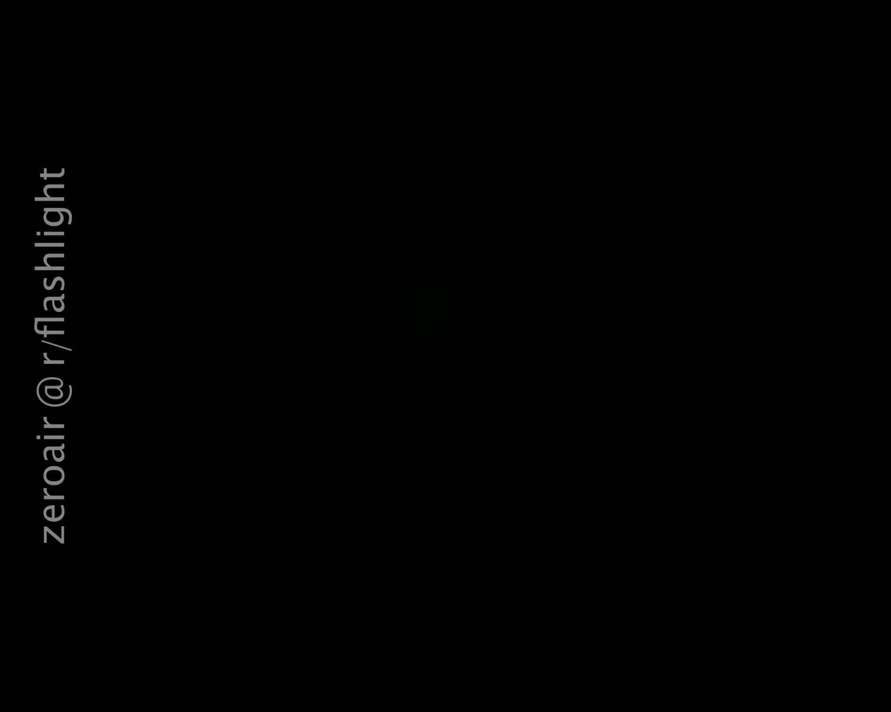 A completely black image with the text zeroair @ r/flashlight vertically aligned on the left side. No other visible objects or details are discernible.