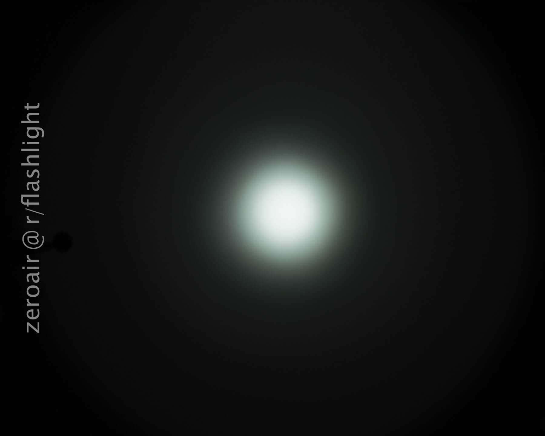 A white circular light beam is centered against a dark background, fading outward. The text zeroair © r/flashlight is vertically aligned on the left side.