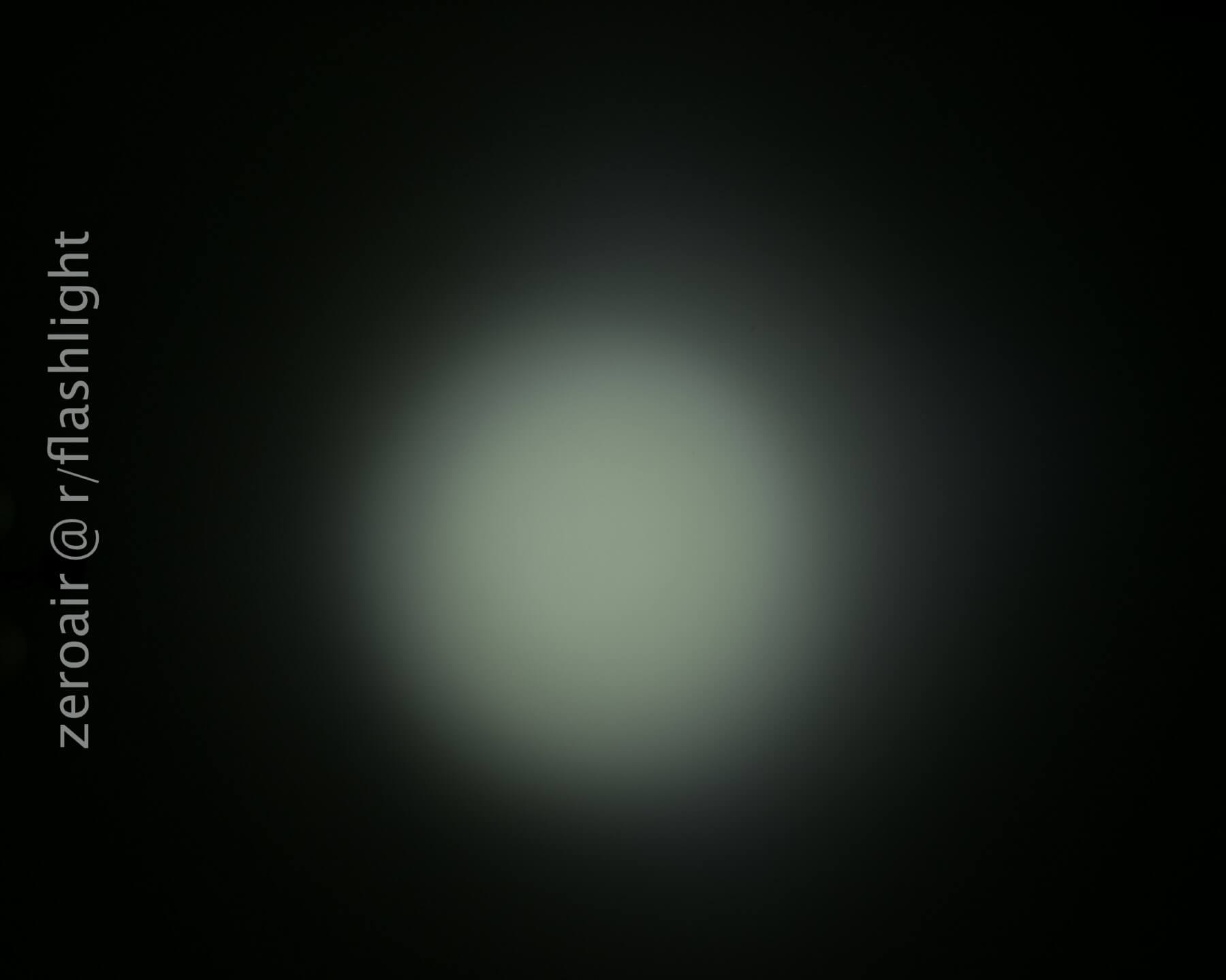 A circular, diffused white light is centered against a dark background. The text zeroair @ r/flashlight appears vertically along the left side of the image.