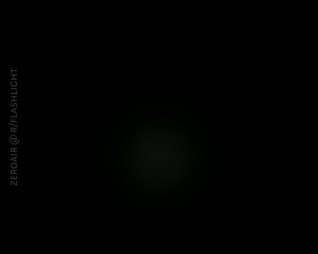 A nearly black image with a faint, small, circular light in the center and the text ZEROAIR @ R/FLASHLIGHT vertically along the left side.