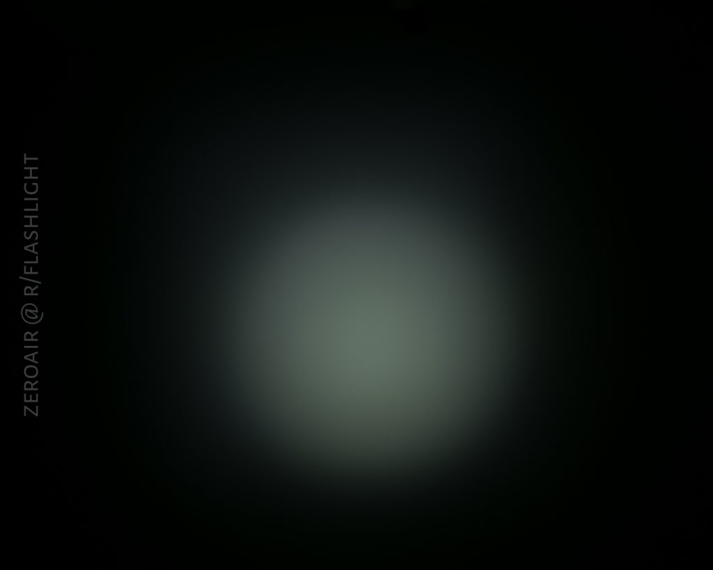 A circular white beam of light, possibly from an Olight S1Rv2, shines on a dark background. The words ZEROAIR @ R/FLASHLIGHT are vertically aligned along the left side of the image.