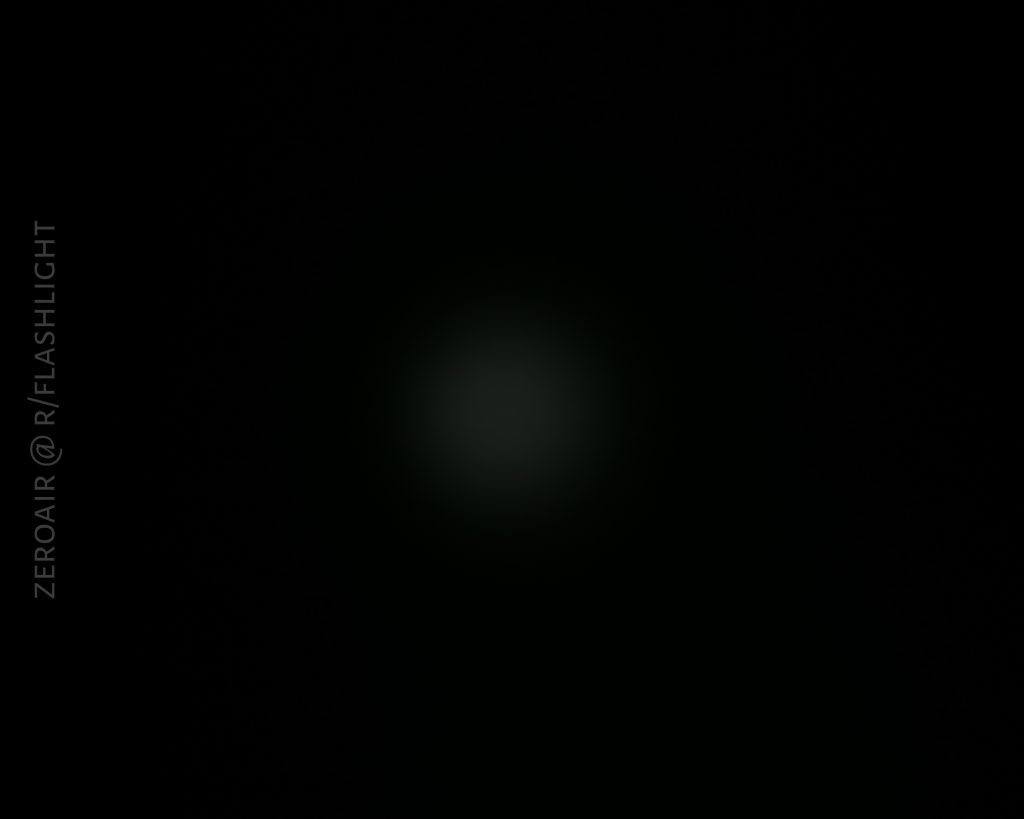 A faint, dim light is visible in the center of an otherwise dark image. The words ZEROAIR @ R/FLASHLIGHT appear vertically along the left edge.