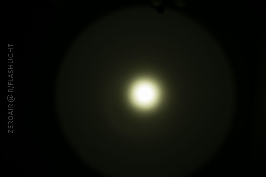 A bright circular light appears in the center against a dark background, creating a gradual halo effect. The text ZEROAIR @ R/FLASHLIGHT is vertically aligned on the left side.