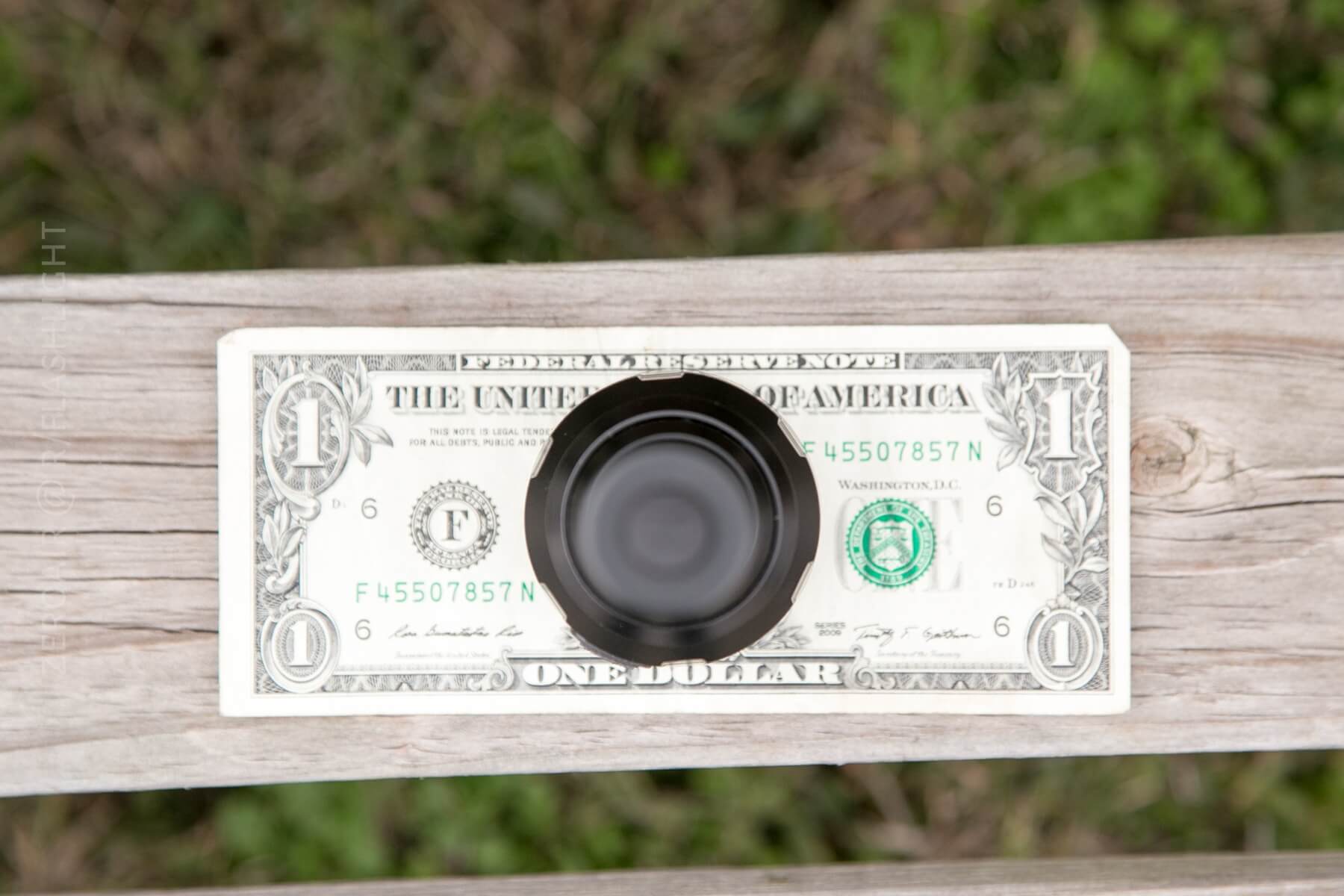Nitecore P30 Flashlight on dollar bill