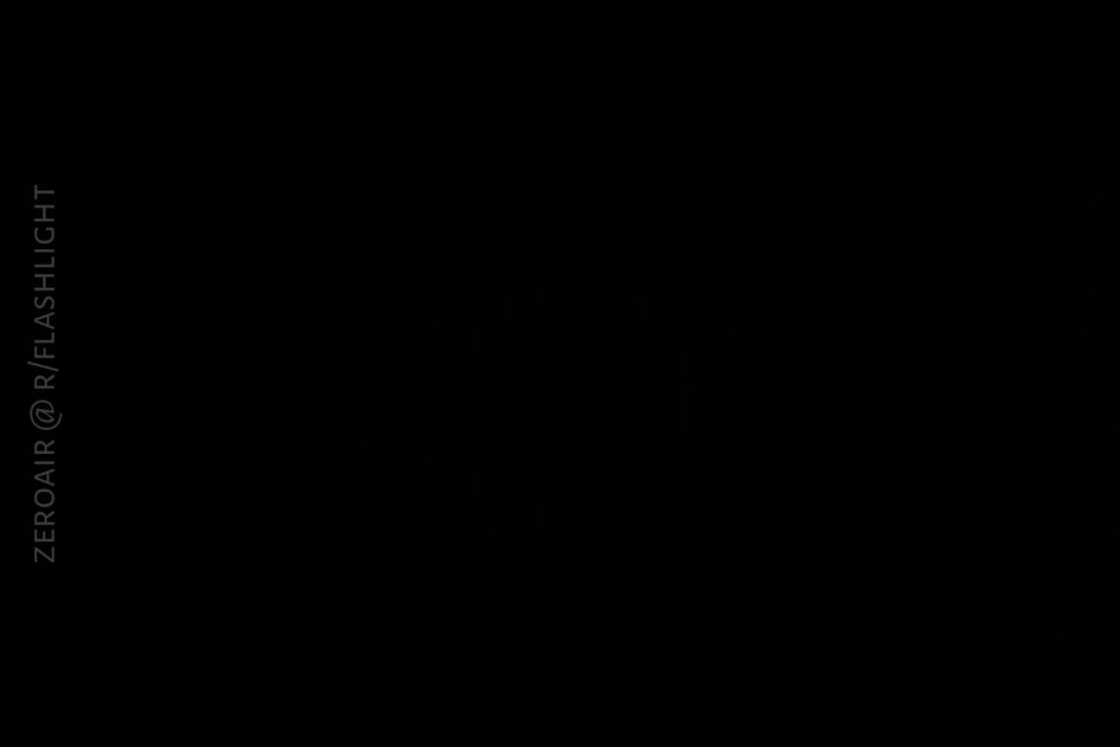 A completely black image with no visible objects or features. The text ZEROAIR @ R/FLASHLIGHT is written vertically along the left edge.
