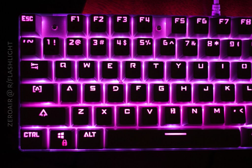 A close-up of a mechanical keyboard with pink backlighting. The keys are clearly visible, and the left Ctrl and Alt keys have unique icons. The image is watermarked ZEROAIR @ R/FLASHLIGHT on the left side.