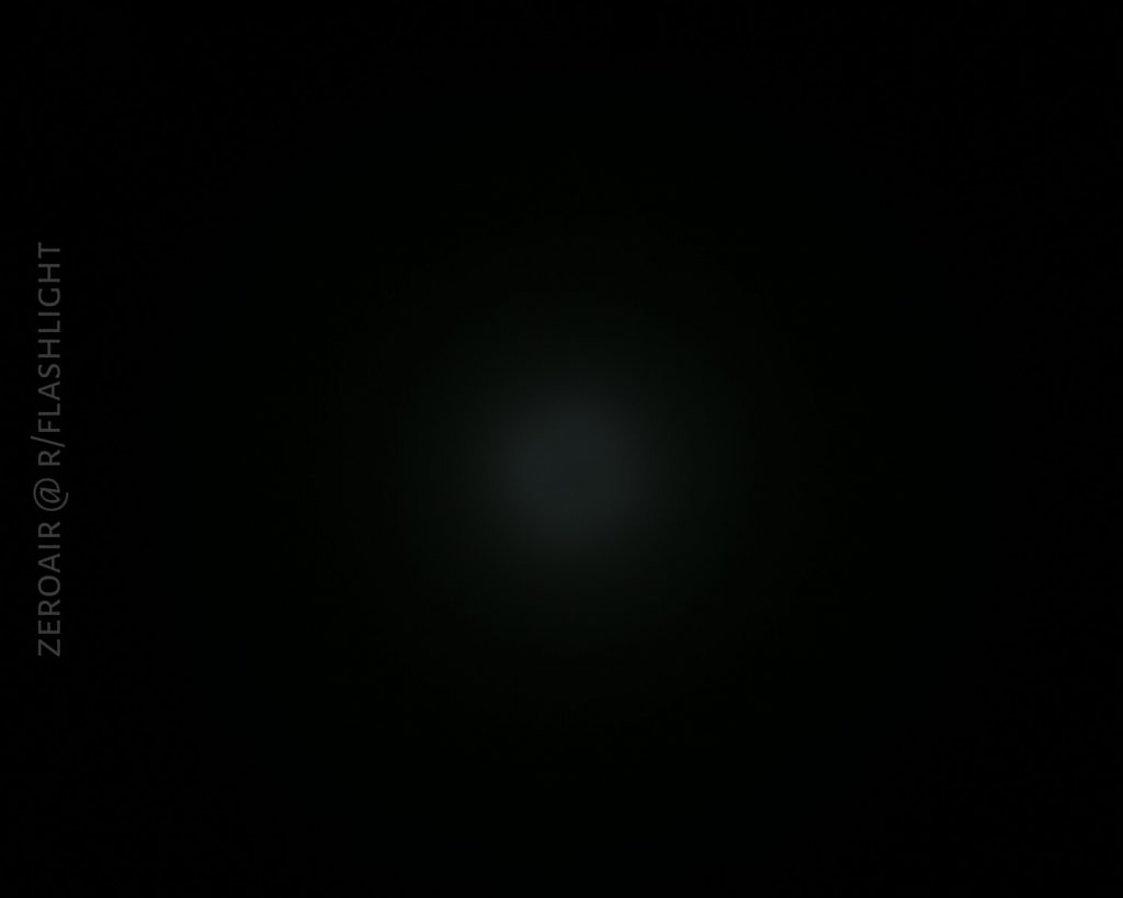 A faint, circular light appears in the center of a mostly black background. On the left side, the text “ZEROAIR @ R/FLASHLIGHT” is vertically aligned.
