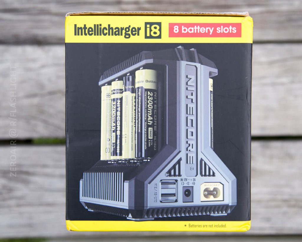 A Nitecore Intellicharger i8 battery charger box showing the device with eight battery slots, some filled with cylindrical batteries. Text highlights the product name and the 8-slot feature.