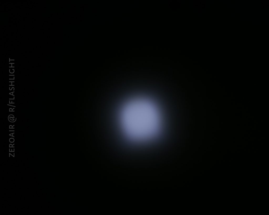 A blurry, square-shaped white light is centered against a black background. The words “ZEROAIR @ R/FLASHLIGHT” appear vertically along the left side.
