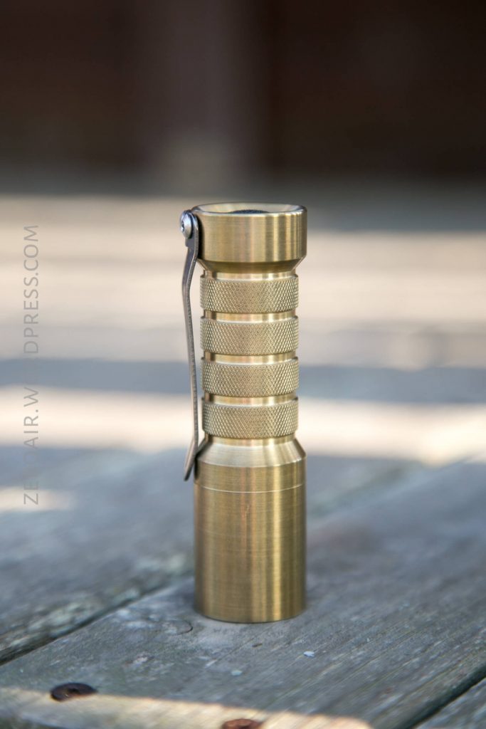 Okluma DC1 Brass Flashlight feature photos headstanding