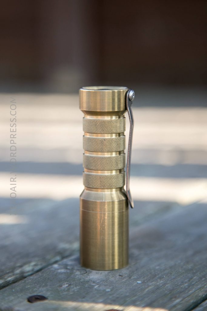 Okluma DC1 Brass Flashlight feature photos headstanding