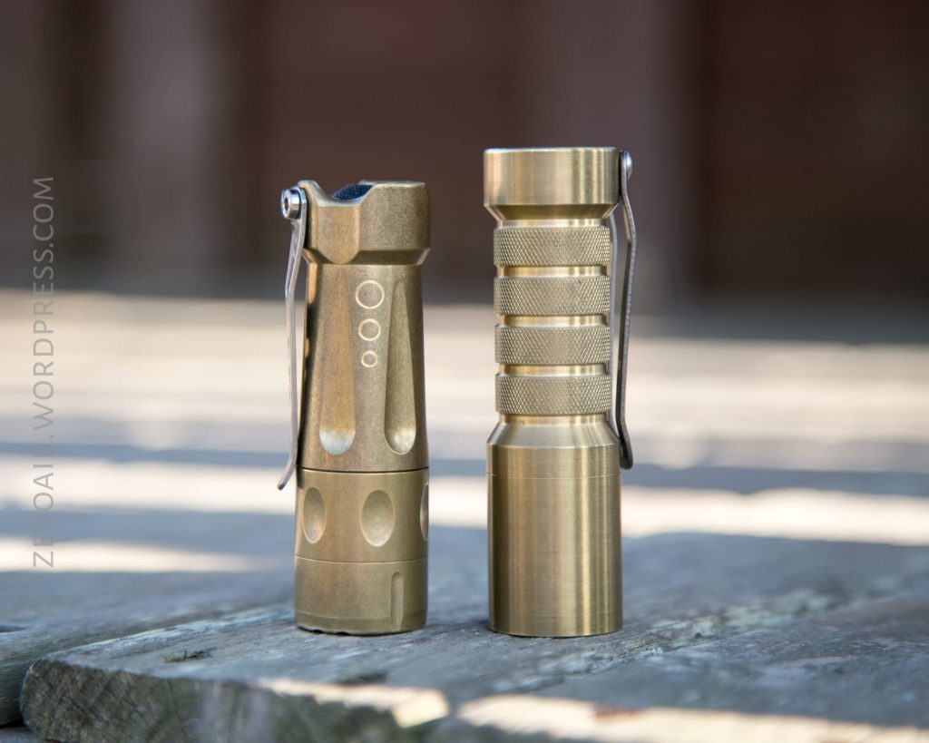 Okluma DC1 Brass Flashlight beside brass torchlab boss 35 brass