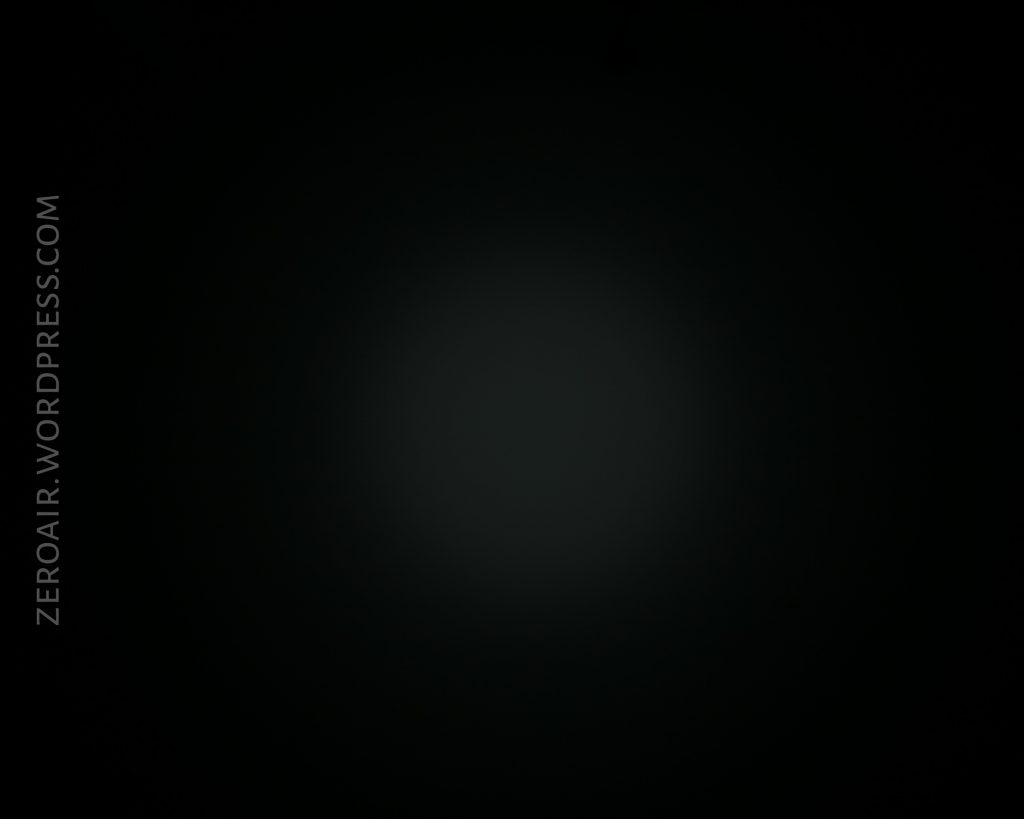 A dark image with a faint, circular light in the center. The words ZEROAIR.WORDPRESS.COM appear vertically along the left side.