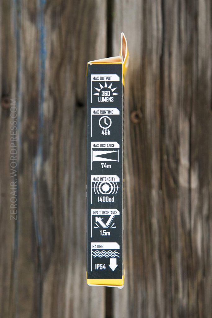 A close-up of the side of a product box displays specifications including 360 lumens max output, 4 hours max runtime, 74m max distance, 1400 candela max intensity, 1.5m impact resistance, and IP54 rating.