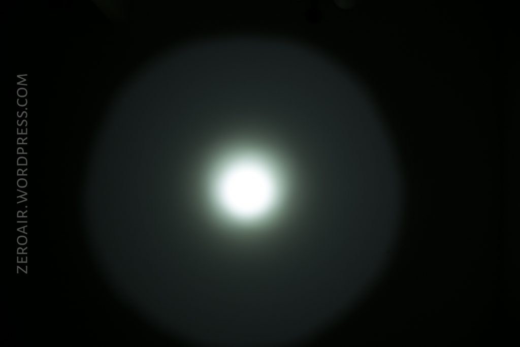 A bright white circular light source is in the center of a dark background, creating a halo effect. The text ZEROAIR.WORDPRESS.COM appears vertically on the left side of the image.