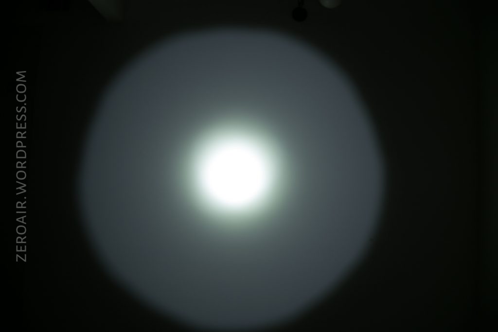 A bright white circular light shines in the center of a dark background, creating a halo effect. The words ZEROAIR.WORDPRESS.COM are written vertically on the left side.