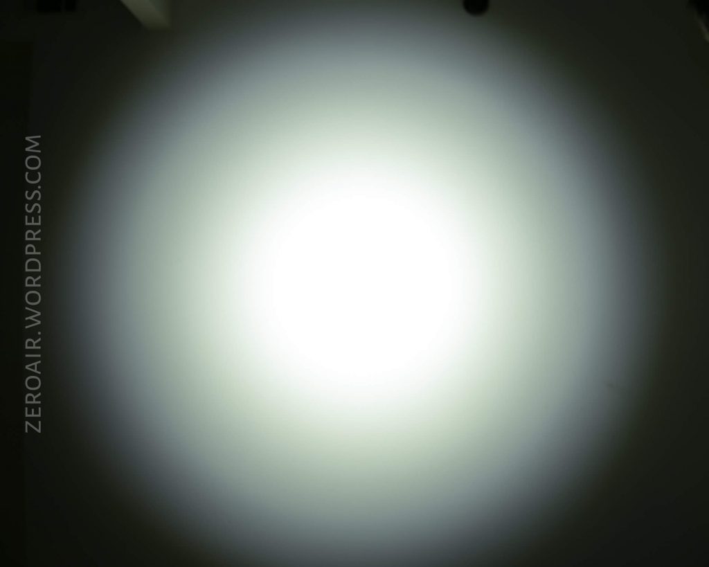 A bright, circular white light shines against a dark background, creating a gradient effect from the center outward. The text “ZEROAIR.WORDPRESS.COM” appears vertically along the left side.