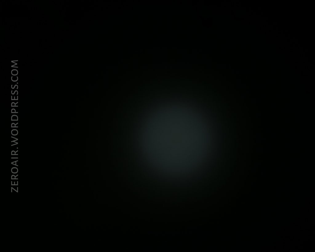 A faint, circular, white light appears in the center of a dark background. The words ZEROAIR.WORDPRESS.COM are vertically aligned on the left side of the image.