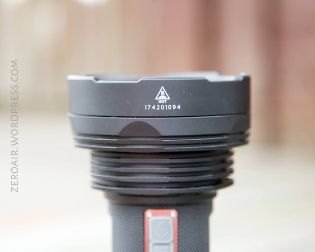 A close-up of a black flashlight head with the label HOT and the number 174201094 printed on it. The background is blurred, and a vertical watermark reads ZEROAIR.WORDPRESS.COM.