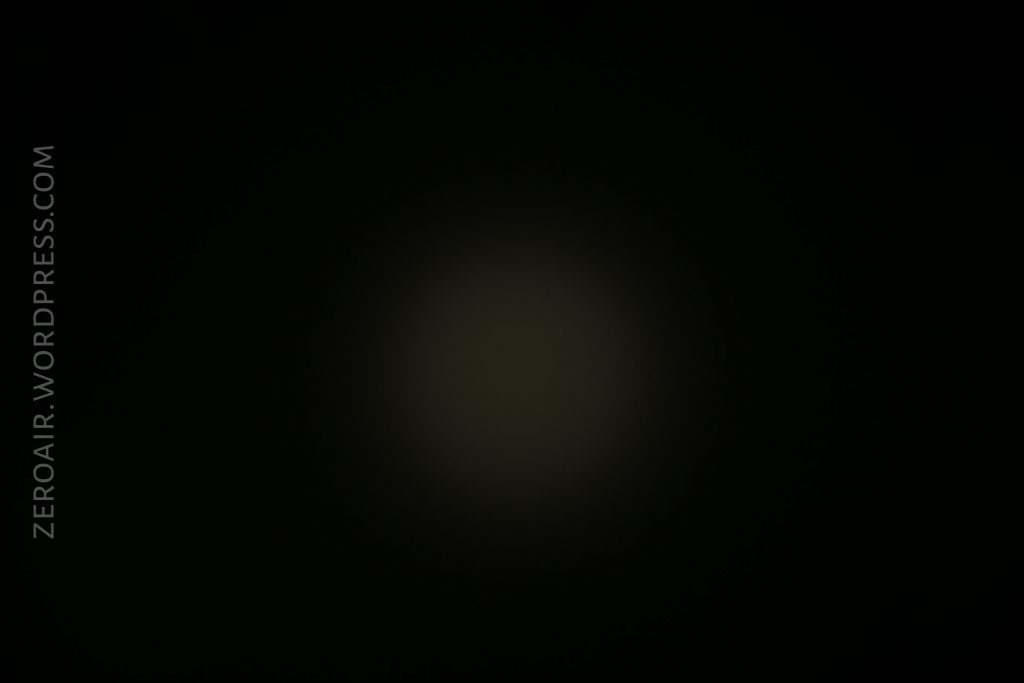 A dim, circular light is visible in the center of a mostly black background. The text “ZEROAIR.WORDPRESS.COM” appears vertically along the left side.