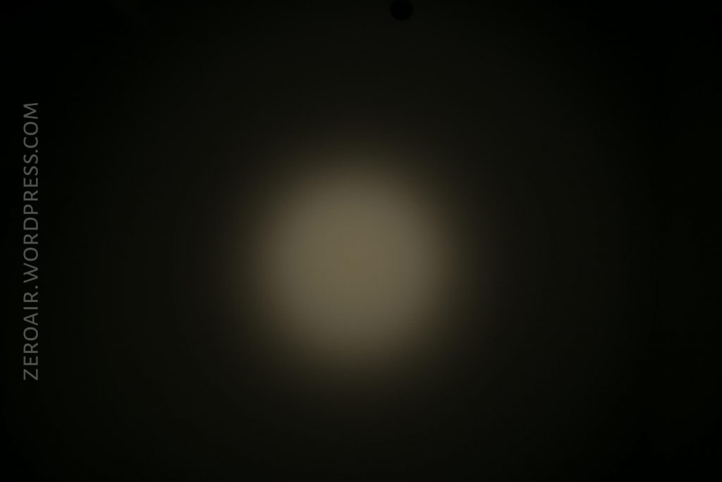 A circular, diffused beam of light appears in the center of a dark background. The words ZEROAIR.WORDPRESS.COM are written vertically along the left side.