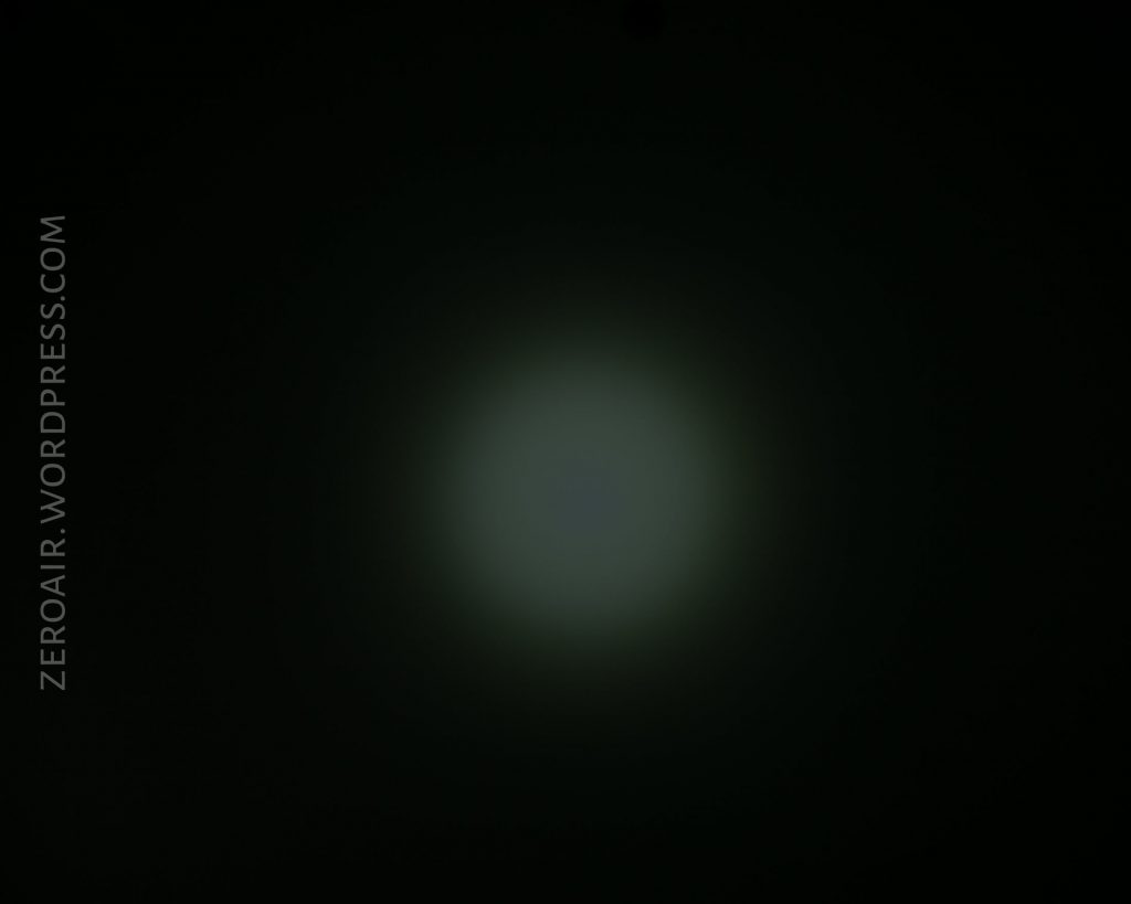 A faint, circular white light shines in the center of a dark background. The light gradually fades out toward the edges. The text ZEROAIR.WORDPRESS.COM appears vertically on the left side.
