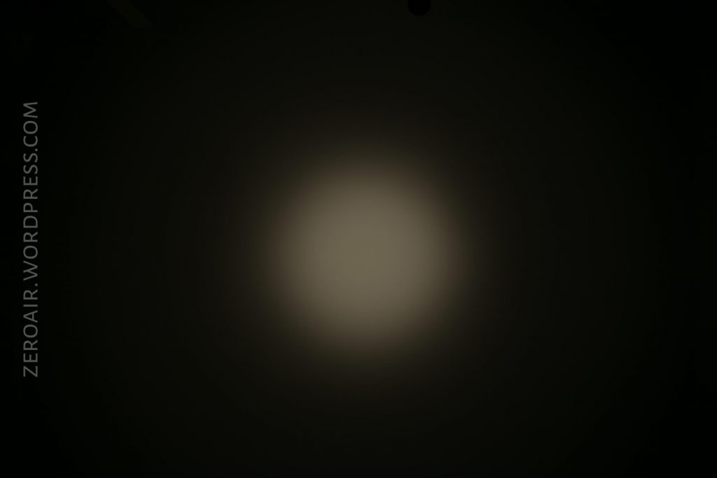 A dim, circular beam of light appears in the center of a dark background. The words ZEROAIR.WORDPRESS.COM are written vertically on the left side of the image.
