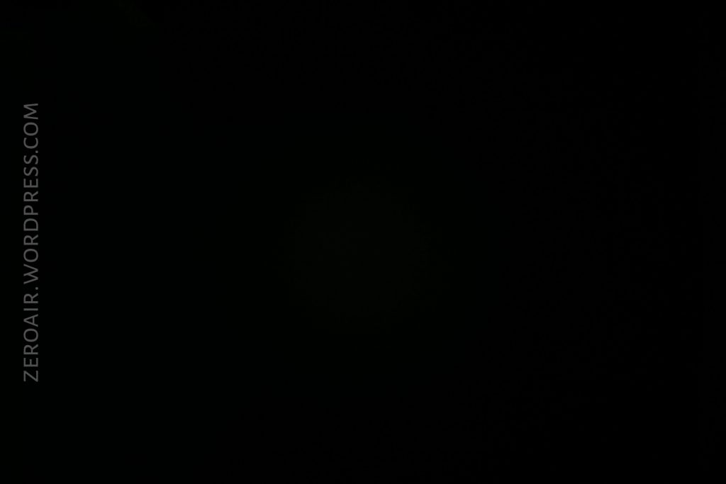 A completely black image with the text ZEROAIR.WORDPRESS.COM in vertical orientation along the left side. No other distinguishable objects or features are visible.