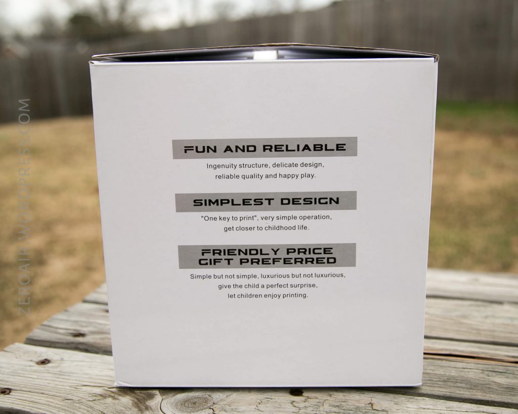 A white box outdoors on a table, featuring three highlighted product features: Fun and Reliable, Simplest Design, and Friendly Price Gift Preferred, with brief descriptions under each heading.