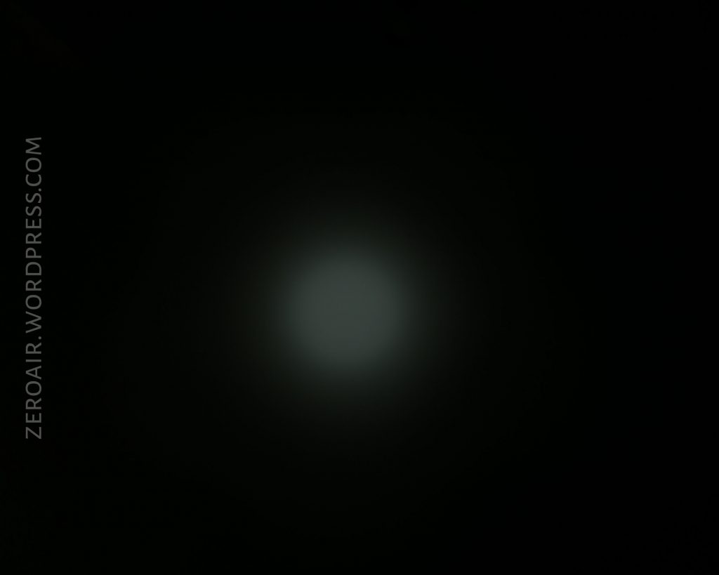A dim, circular white light appears in the center of a black background. The text ZEROAIR.WORDPRESS.COM is vertically aligned on the left side of the image.