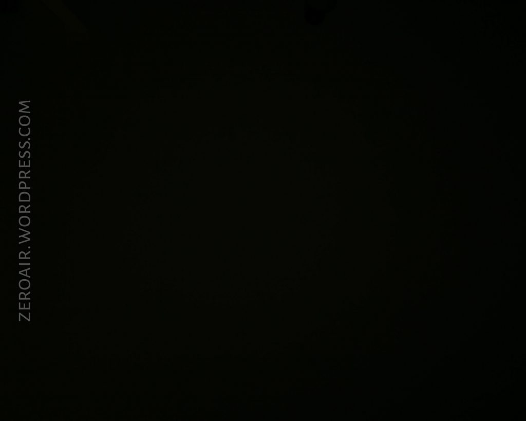 A dark, almost black image with the text ZEROAIR.WORDPRESS.COM vertically aligned on the left side. No other objects or details are visible.