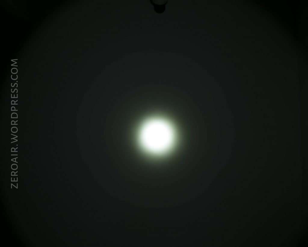 A bright, circular white light appears in the center of a dark background. The glow fades gradually outward. The text ZEROAIR.WORDPRESS.COM is written vertically along the left side of the image.