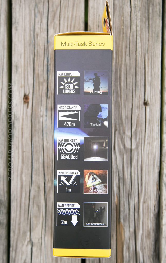 A yellow and black product box displays specifications: 1800 lumens max output, 470m max distance, 55,400 candela max intensity, impact resistance 1m, waterproof to 2m, with icons for various uses like hunting and outdoor activities.