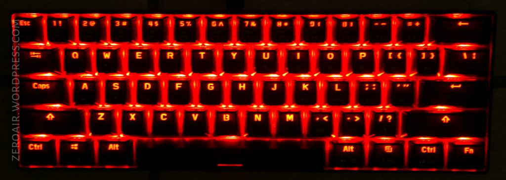 A compact keyboard with red backlighting, showing a standard QWERTY layout and modifier keys like Ctrl, Alt, and Fn. The branding ZEROAIR.WORDPRESS.COM appears along the left edge.