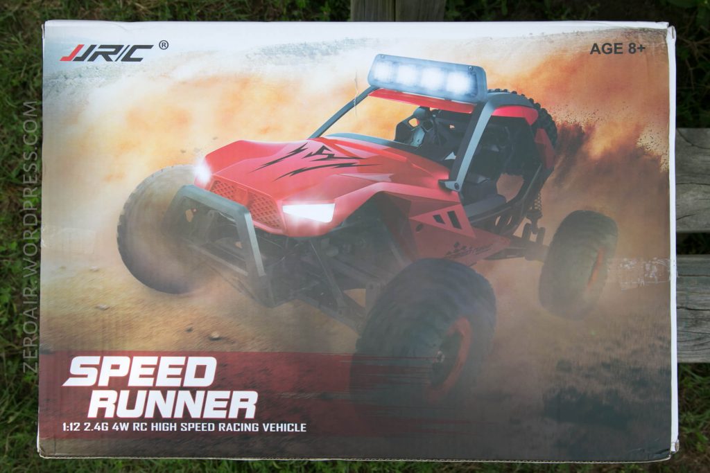 A product box showing a red JJRC Speed Runner 1:12 scale 2.4G 4WD RC high speed racing vehicle with large tires, an LED light bar, and dust effects. The box also displays AGE 8+ in the top right corner.