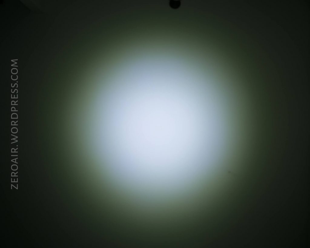 A circular beam of white light with a soft blue tint shines on a dark background, creating a gradient effect from the center outward. The text ZEROAIR.WORDPRESS.COM appears vertically on the left side.