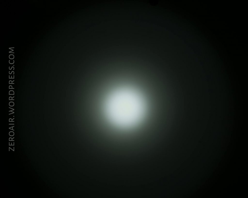 A circular white light is centered against a dark background, creating a diffused halo effect. The words ZEROAIR.WORDPRESS.COM appear vertically on the left side of the image.