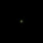 A small, dim white circle of light is centered against a black background. The text ZEROAIR.WORDPRESS.COM appears vertically along the left side of the image.
