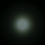 A dim white light is centered against a dark background, creating a soft circular glow. The text ZEROAIR.WORDPRESS.COM appears vertically on the left side of the image.