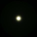 A bright white circular light is centered in a dark background, creating a soft halo effect. The text ZEROAIR.WORDPRESS.COM appears vertically along the left side of the image.