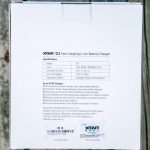 The back of an XTAR D2 Fast-charging Li-ion Battery Charger box displays technical specifications, package contents, manufacturer details, and warranty code on a white background.
