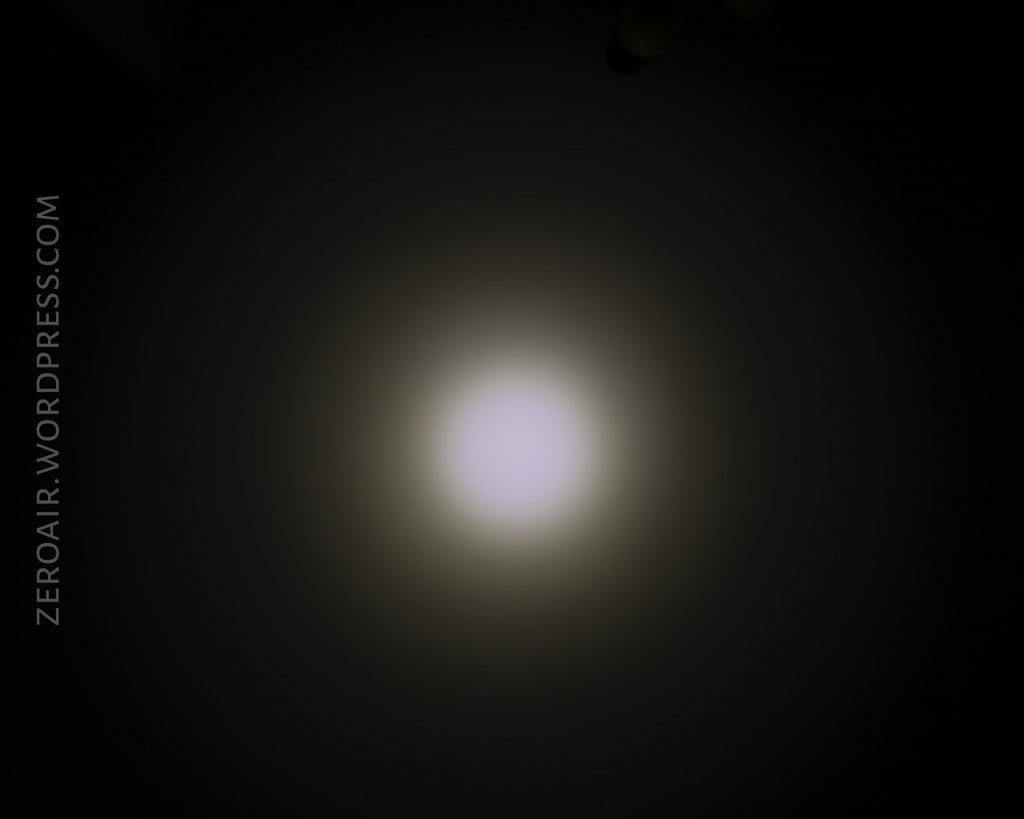 A bright circular white light appears in the center of a dark background with a gradient halo effect. The text ZEROAIR.WORDPRESS.COM is vertically aligned on the left side of the image.
