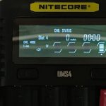 Close-up of a Nitecore UMS4 battery charger display showing Slot 4 with 0 mAh charged, 4.2V in CV mode, and a charging time of 00:00. The charger has visible mode and slot buttons.