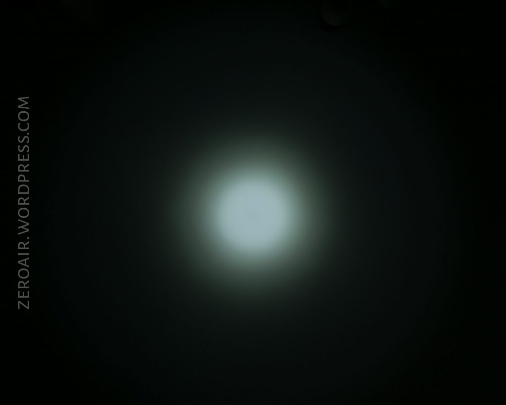 A soft, circular white light glows at the center of a dark background. The text ZEROAIR.WORDPRESS.COM is written vertically along the left side of the image.