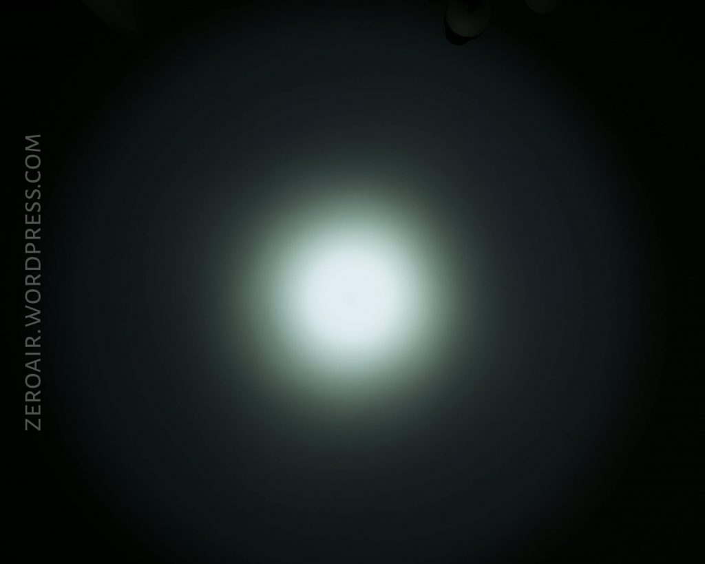 A bright white circular light source creates a halo effect against a dark background. The text ZEROAIR.WORDPRESS.COM appears vertically on the left side of the image.