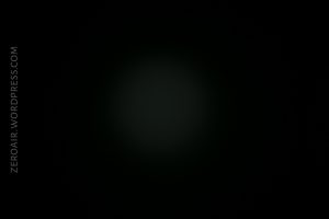 A mostly dark image with a faint, circular light spot in the center. The left edge displays vertical text that reads ZEROAIR.WORDPRESS.COM.