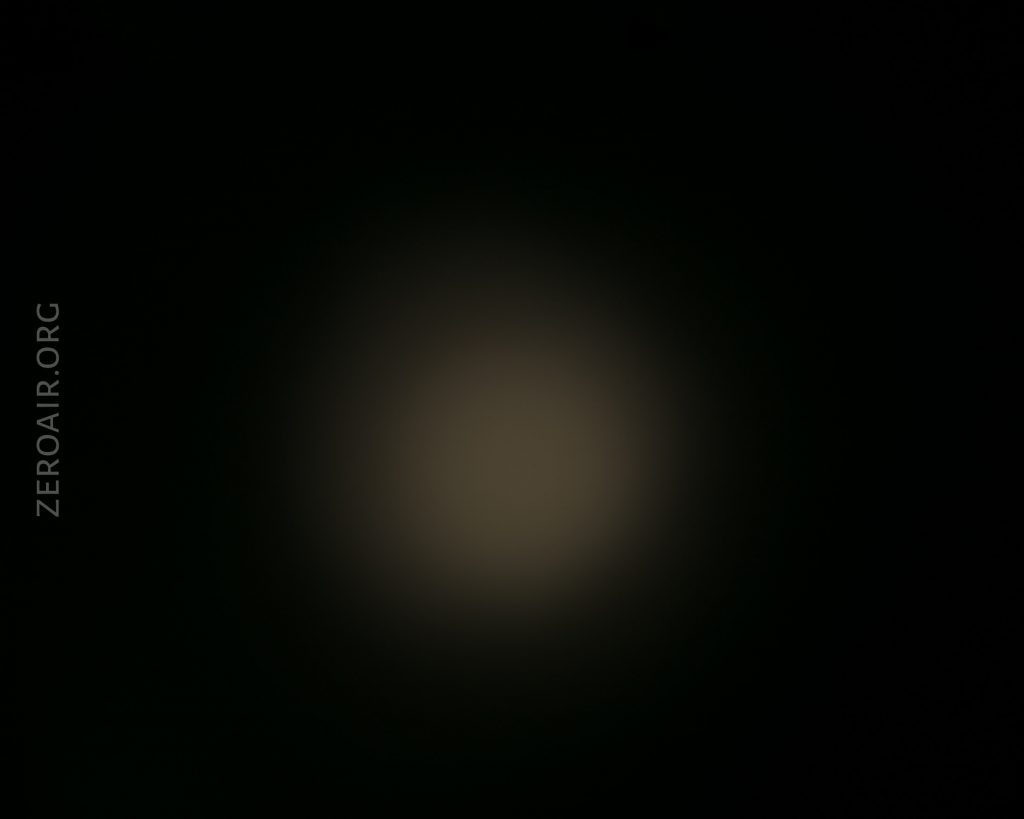 A faint, circular, yellowish light appears in the center of a mostly black background. The text ZEROAIR.ORG is vertically aligned on the left side of the image.