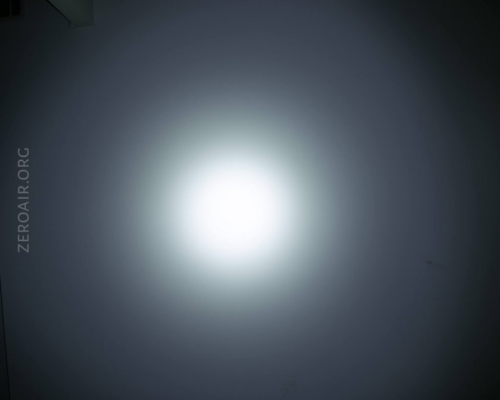A bright white circular light shines at the center of a dark background. The text ZEROAIR.ORG appears vertically on the left side of the image.