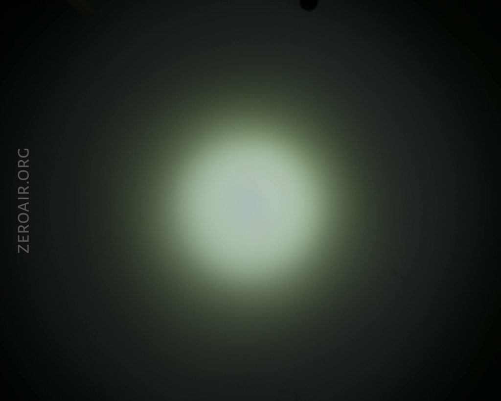 A dim white circular light appears in the center of a dark background. The word ZEROAIR.ORG is written vertically along the left side of the image.