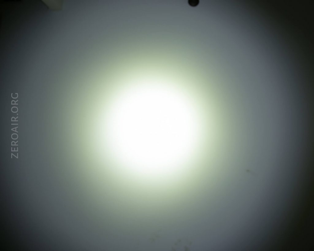 A bright white circular light shines in the center of a dark background, creating a halo effect. The word ZEROAIR.ORG is faintly visible on the left side of the image.